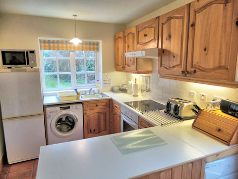 Kitchen with microwave oven, full-size dishwasher, washing machine & tumble dryer